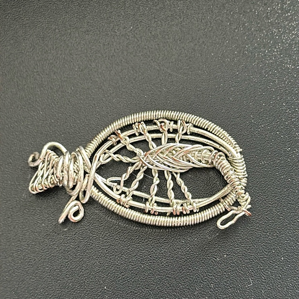 Wire jewelry. I received as a gift I think it is a scorpion or cow.